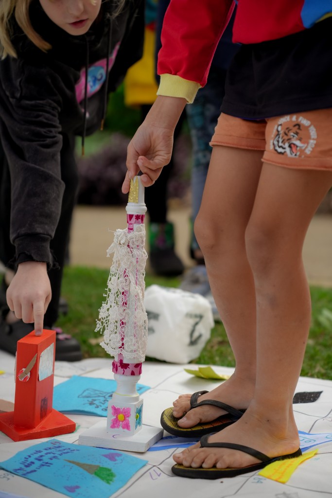 Detail of pawn being handled during play. Created by children for Up and Down Queen Street